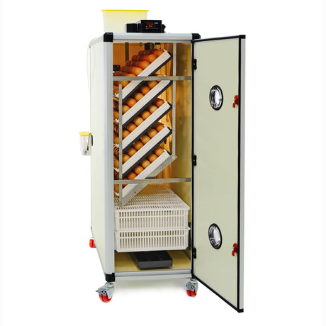 Hatching Time Cimuka. HB series incubator seen with door open showing setting trays and hatching baskets full of brown chicken eggs. Digital control and water reservoir tank can be seen on top of incubator.