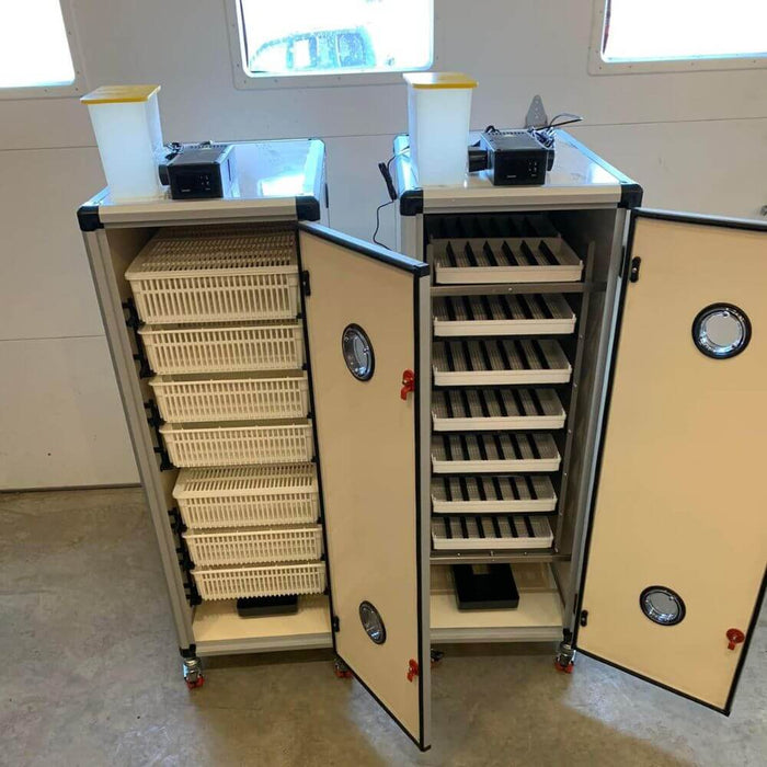 Hatching Time Cimuka. HB incubators can be seen sidy by side. The incubator on the left is a hatcher, the incubator on the right is a setter. Both incubators have digital controls on top connected to humisonic humidity system.