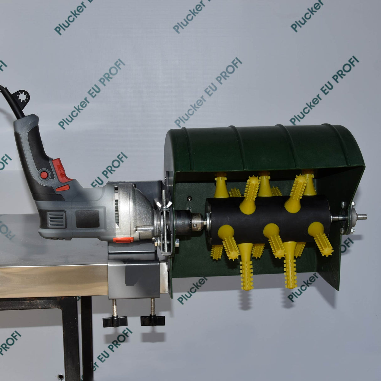 EU ProA drill-powered feather plucker mounted on a stainless steel desk, featuring yellow rubber fingers and green protective hood for poultry processing
