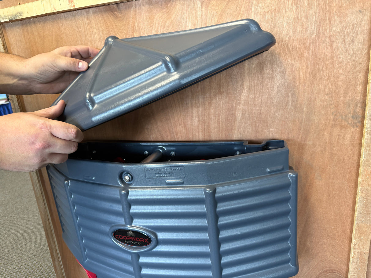 Hatching Time Silo wall mounted Coopworx Feeder and Drinker mounted lid being placed on.