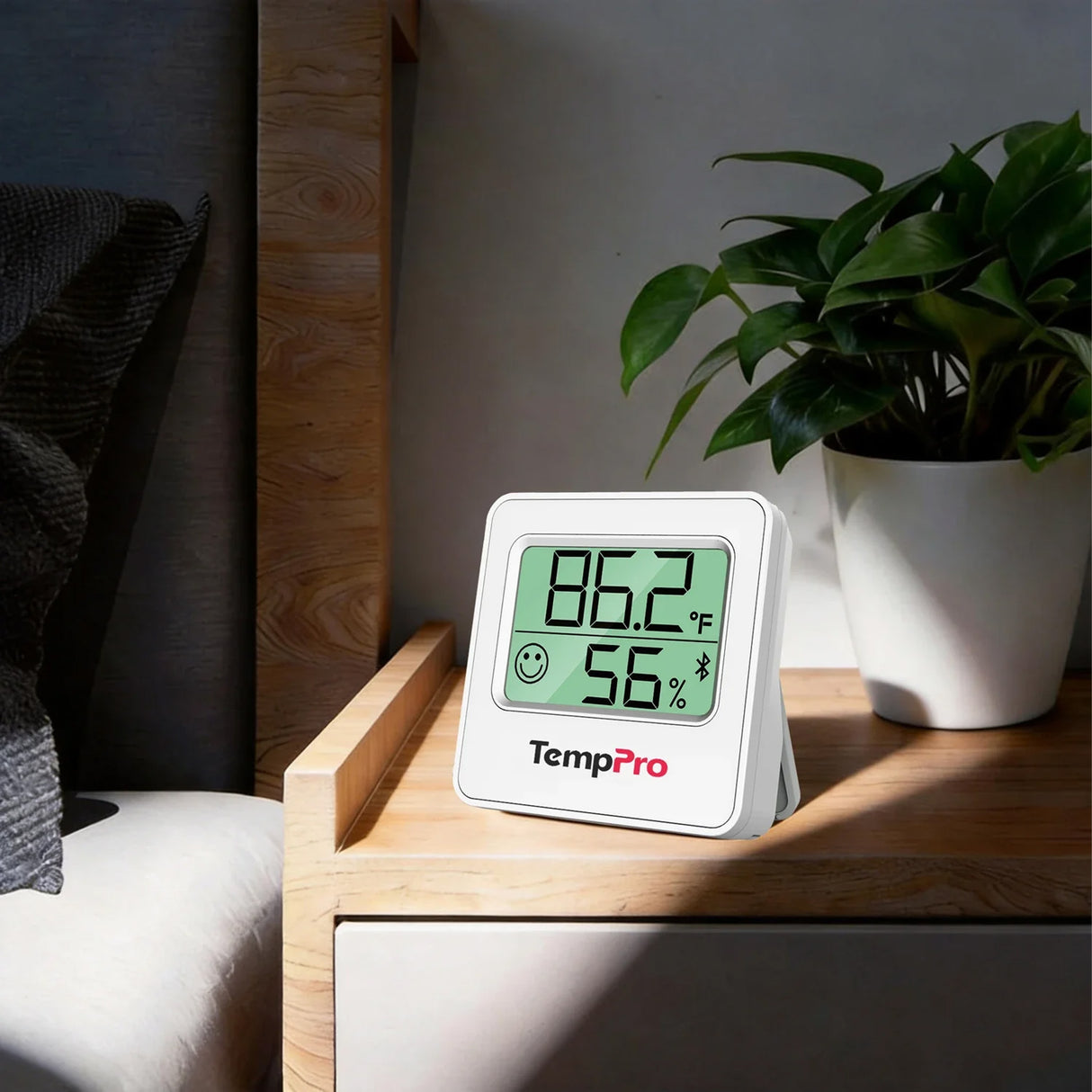 TempPro TP357 Bluetooth Thermometer Hygrometer on a Nightstand with Indoor Temperature and Humidity Display
