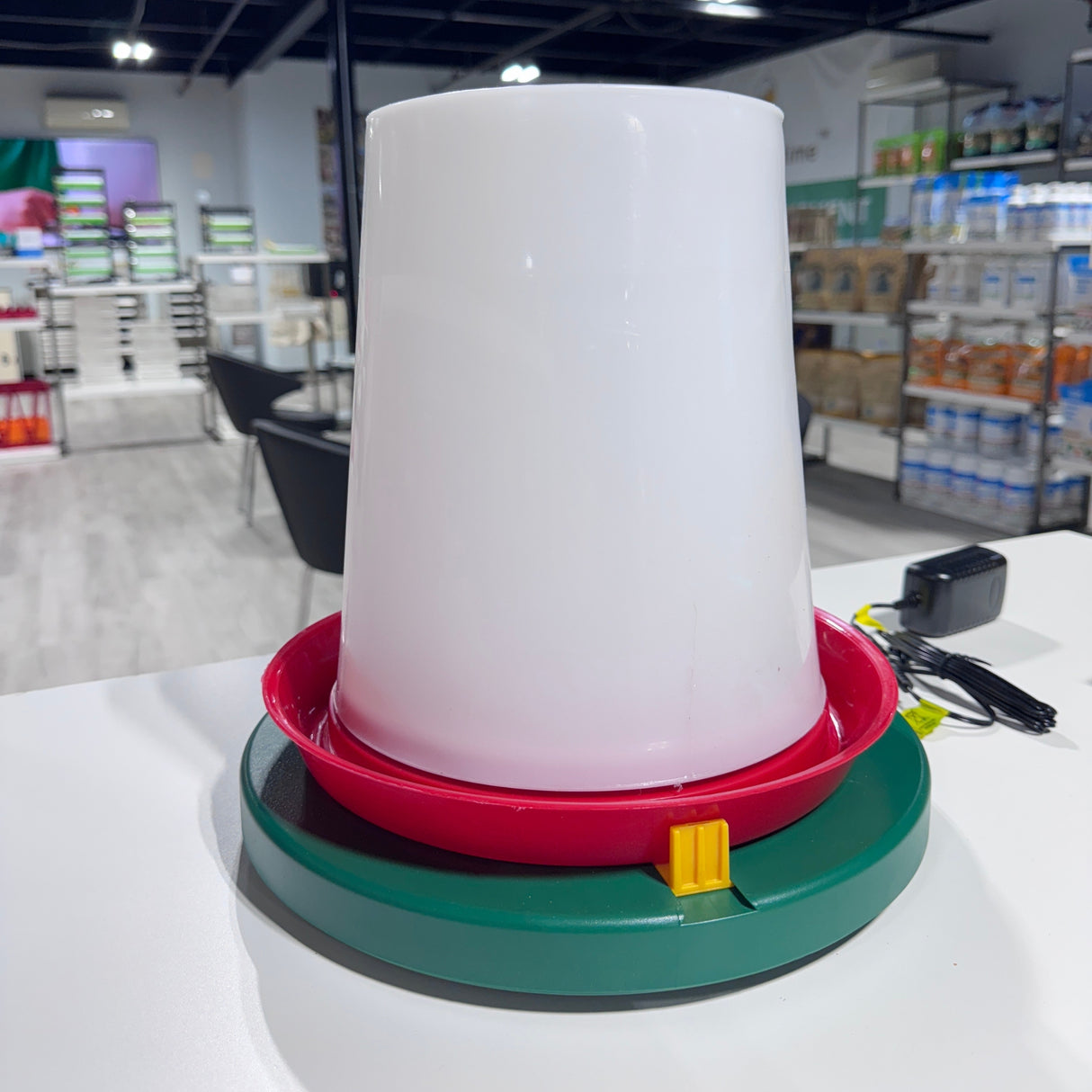 Hatching Time. Water drinker can be seen placed on drinker heater on shelf in warehouse.