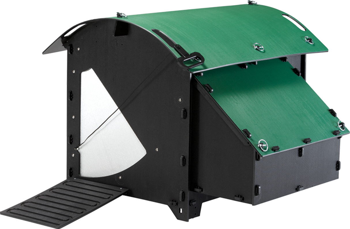 Hatching Time Nestera. Medium coop can be seen in image. Nesting box can be seen on side of coop. Ramp leading up to door is in front of coop. Automatic coop door opener is closed.