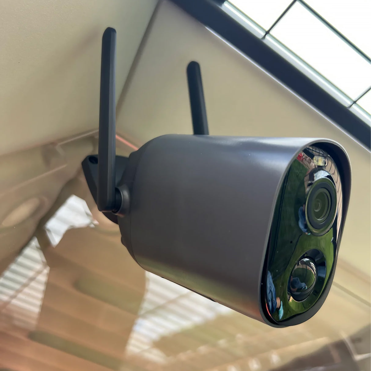 Outdoor Hatching Time Coop Cam camera mounted on a wall with a clear sky background