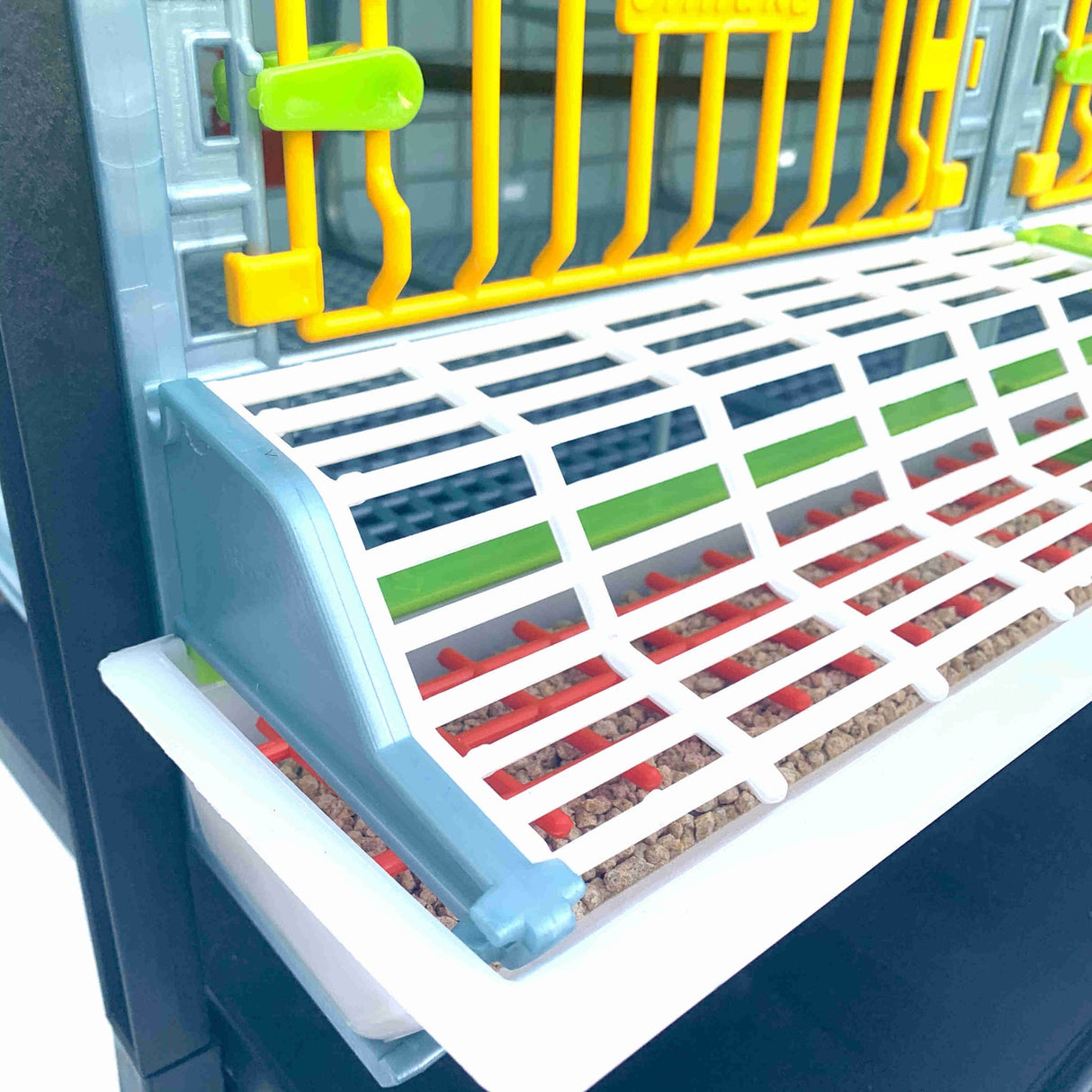 Hatching Time Cimuka. GL25 9.5” Grow out pen angled view of front showing feeder trough, trough cover and front door.