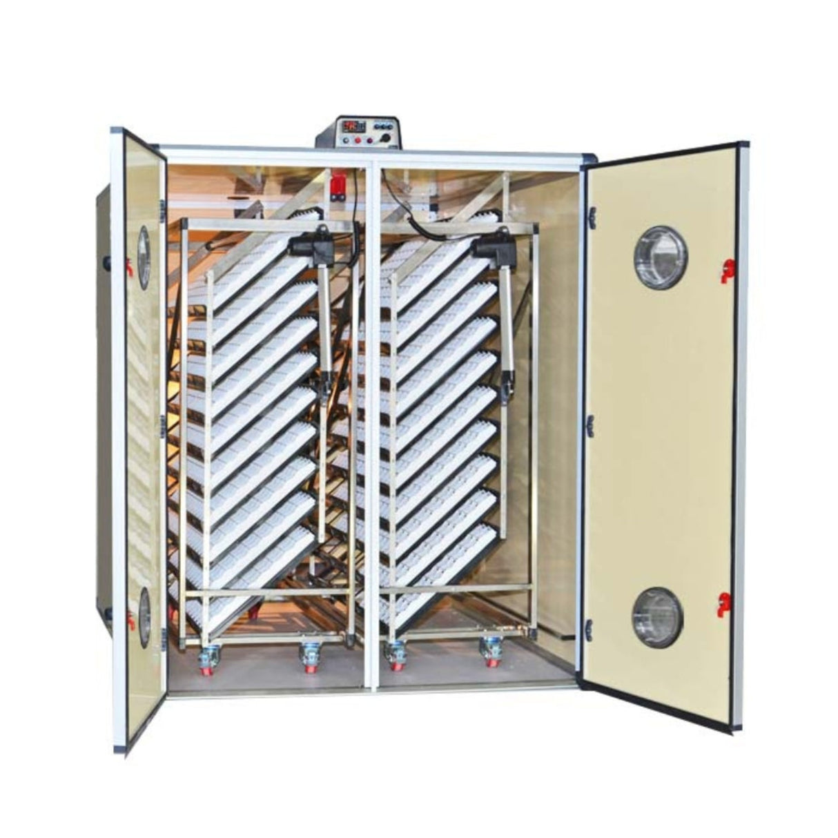 Hatching Time Cimuka. T4800SH image shows incubator with open door with setting trays inside. Humidity Tray can be seen on floor of incubator. Digital control on top of incubator is in front of water reservoir tank connected to Humisonic Humidifier. Egg trays are mounted on trolleys.