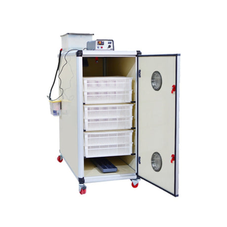 Hatching Time Cimuka. Egg Incubator can be seen with door open showing 6 hatching baskets inside. Humidity tray on floor of incubator. Digital control on top of incubator is in front of water reservoir tank connected to Humisonic humidifier.