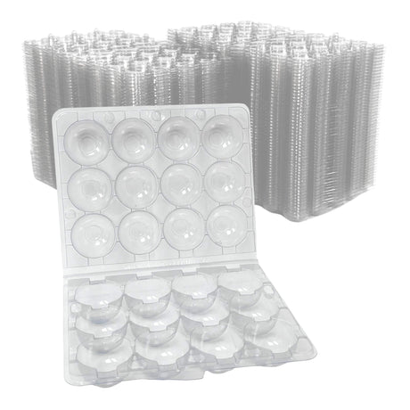 Clear plastic egg cartons with a large stack of similar cartons in the background.