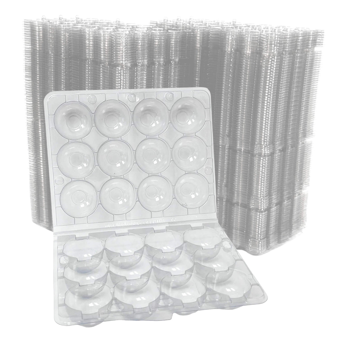 Clear plastic egg cartons with a stack of similar cartons in the background.