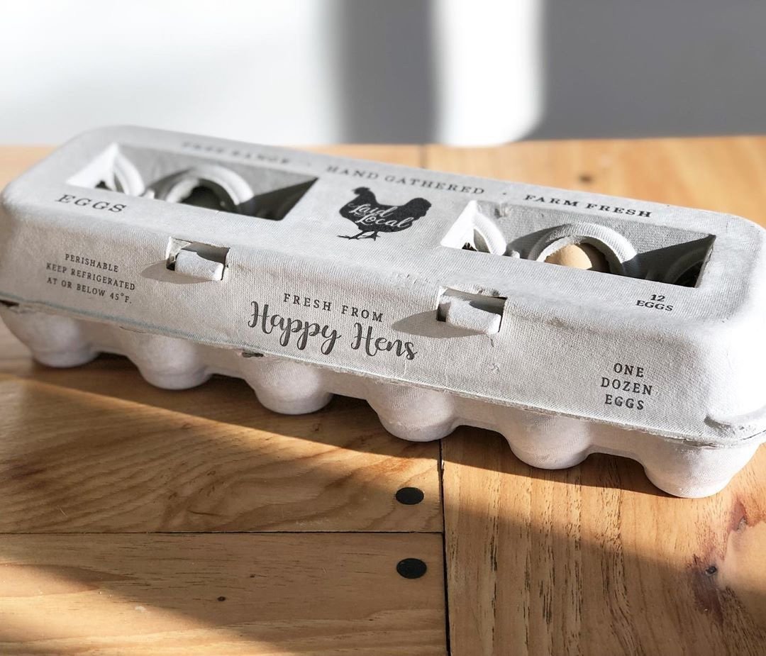 Hatching Time Henlay Egg Carton pre-marked with free range, hand gathered, farm fresh and laid local branding on table.