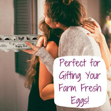 Eggs being gifted in Henlay egg carton. 2 women are seen hugging, one has a carton of eggs in her hand.