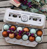 Egg carton on table with Wild Feather Farm stamp shown.