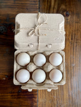 Eggs in Natural Egg carton on table.