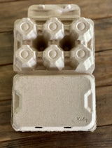 Hatching Time Henlay. 6 duck egg capacity natural egg carton upside down on table showing Henlay brand mark.