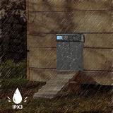 Hatching Time. Automatic coop door can be seen on the side of chicken coop in rain, showing IPX3 water-proof rating.