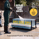 Person power washing the plastic quail breeding cage layer addition outdoors