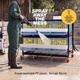 Person power washing the plastic 2-layer quail breeding cage outdoors