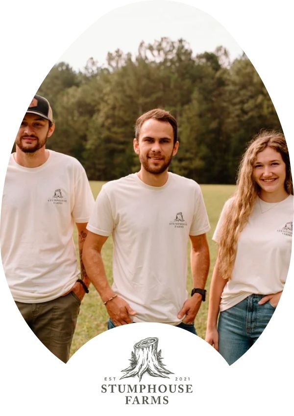 Hatching Time Stumphouse Farms. 2 men and a woman from Stumphouse farms are standing side by side in a field.