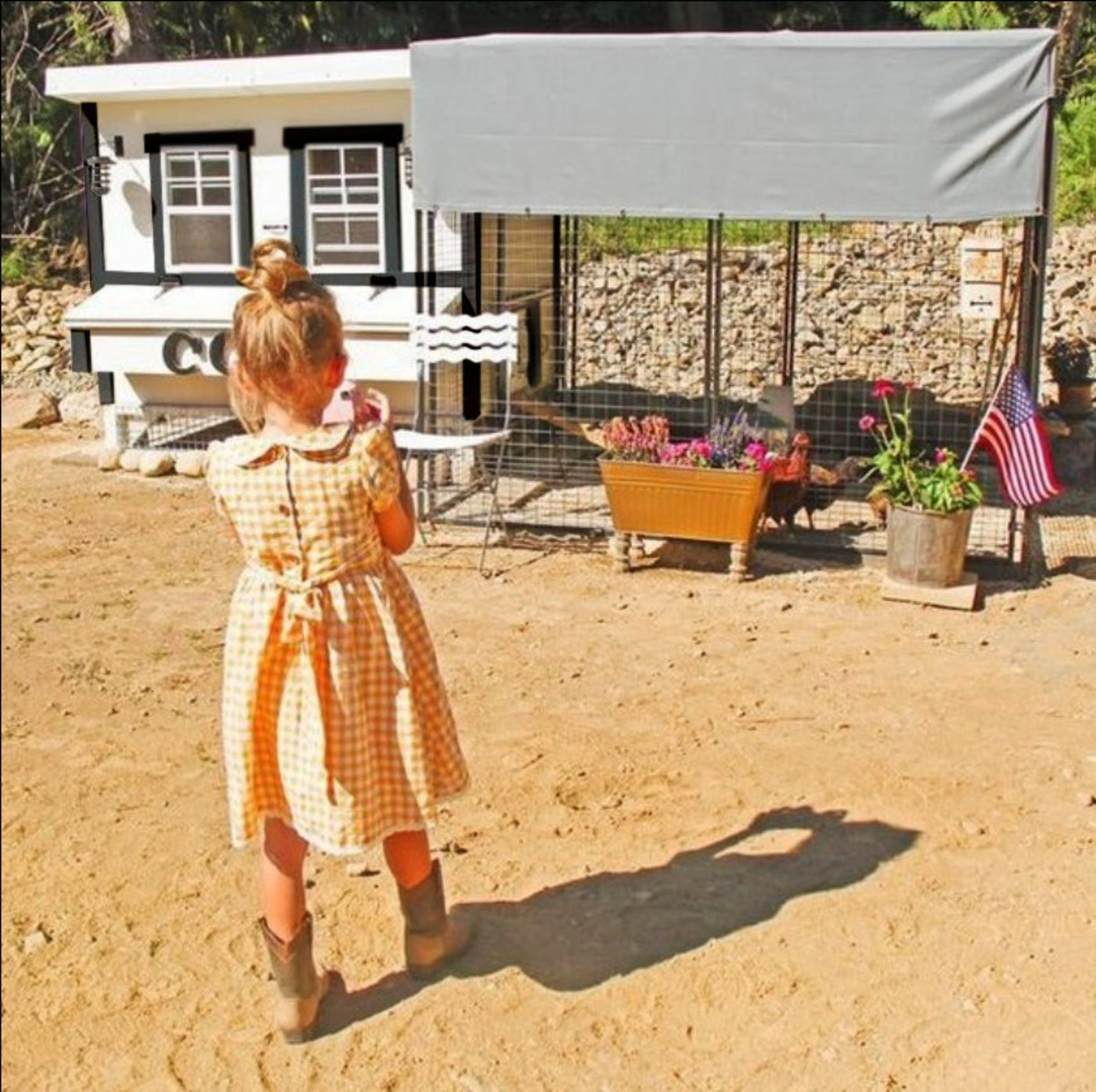 Hatching Time OverEZ. A little girl can be seen in image standing in front of white chicken coop and chicken run.