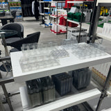 Hatching Time. Clear plastic egg cartons can be seen on shelf in warehouse.