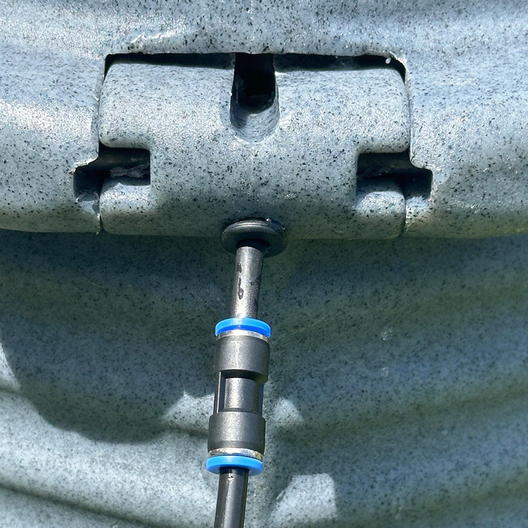 Hatching Time Coopworx. Close up view of back hinge of installed hudson valve on water silo.