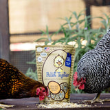 Hatching Time Treats for Chickens. 2 chickens can be seen eating Pullet Together treats for chickens. Chickens are on table next to bag of Pullet Together treats.