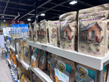 Hatching Time. Grubterra and Treats for chickens brands can be  seen next to other treats on shelves in Hatching Time Showroom shelves.