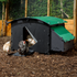 Hatching Time Nestera. Large house chicken coop is on wood chips with chickens inside and around it. Nesting box can be seen on side of chicken coop. Rounded roof is to discourage roosting on top. Ramp for easy chicken access leads to coop door that is opened with automatic coop door opener.