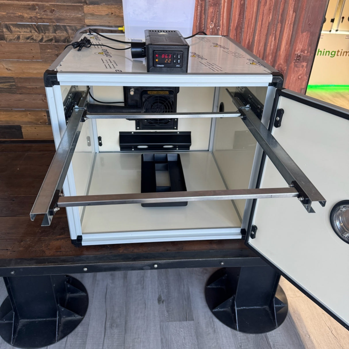 Hatching Time. Front of Queen bee incubator open with rack sticking out to show mobility.