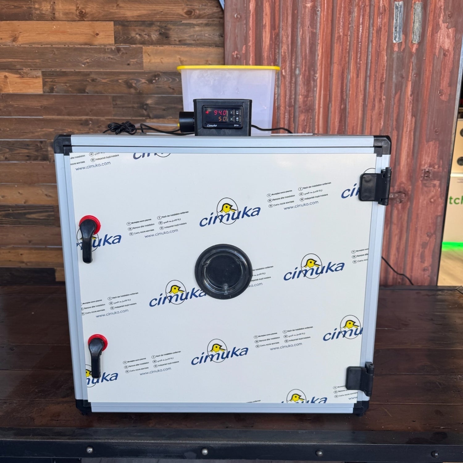 Hatching Time. Queen Bee Incubator can be seen on table with door closed. Digital controls can be seen on top of incubator.