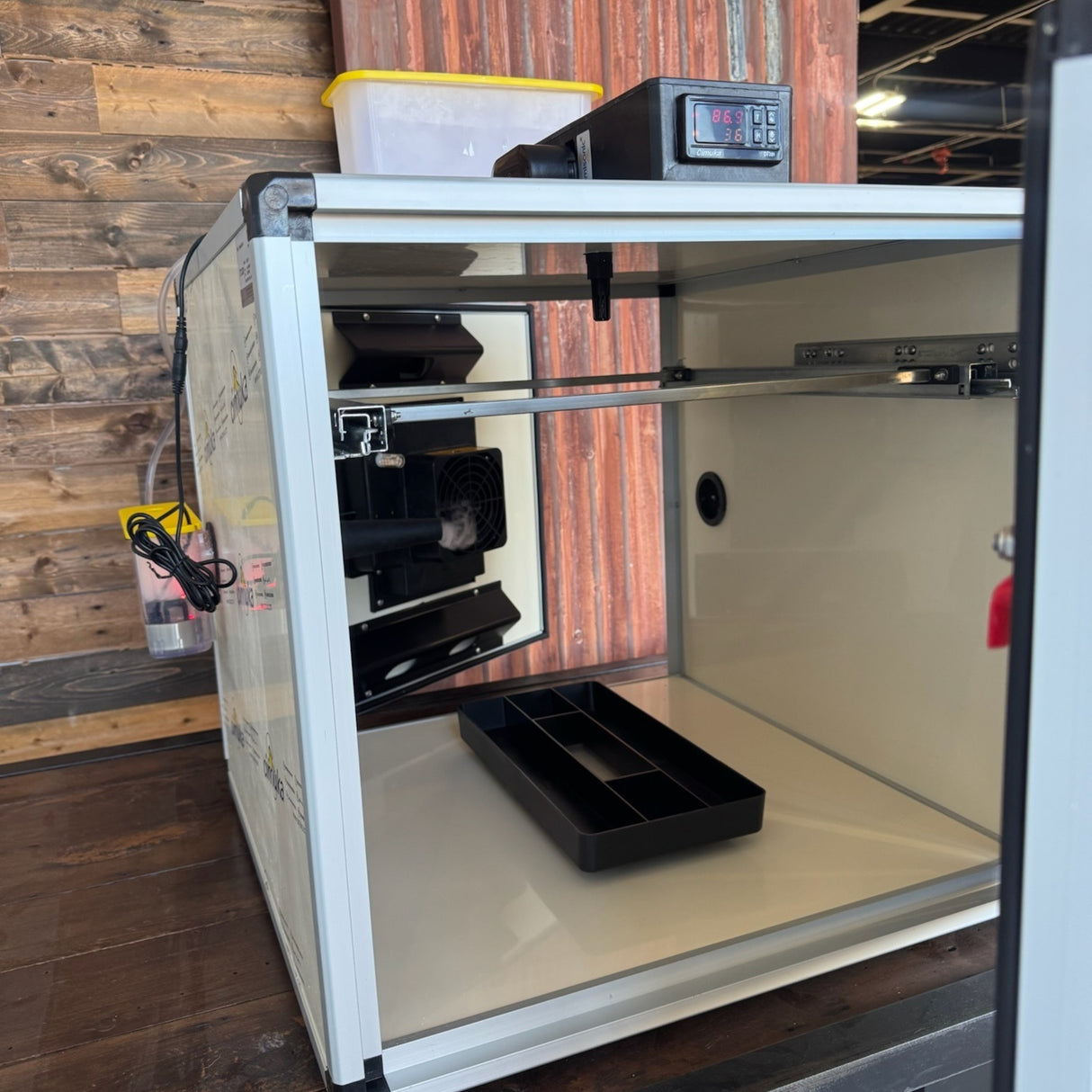 Hatching Time. Queen bee incubator interior can be seen with dual doors open for easy cleaning.
