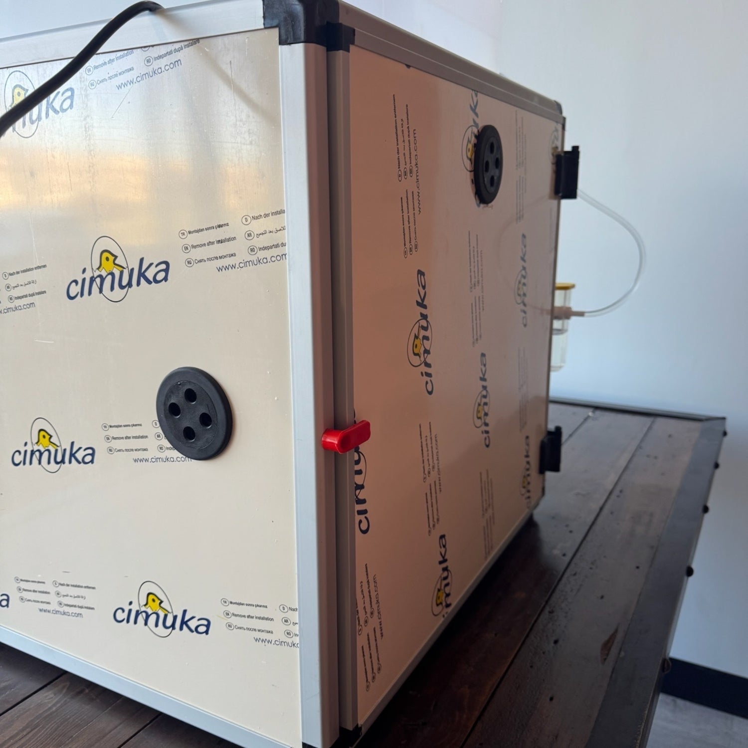 Hatching Time. Queen bee incubator back door can be seen closed with red lock to provide insulated seal.