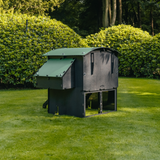 Hatching Time Nestera. Large Raised coop can be seen in image on grass from behind. Nesting box is on side connected to chicken coop, with lifting door for easy egg access. Roof of coop is slanted to prevent roosting.