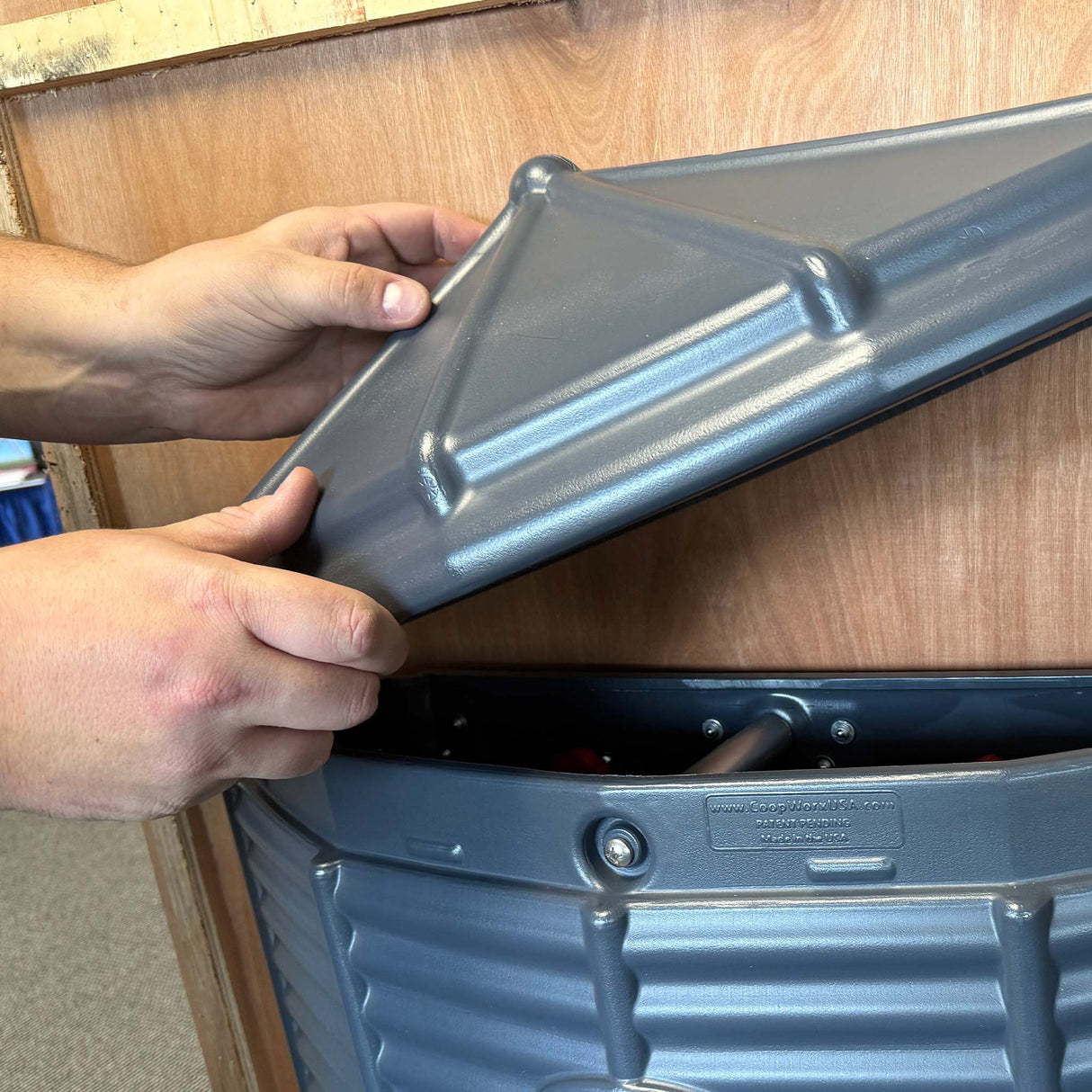 the lid being placed on the Silo Feeder (Wall Mount) after it has been secured to the wall