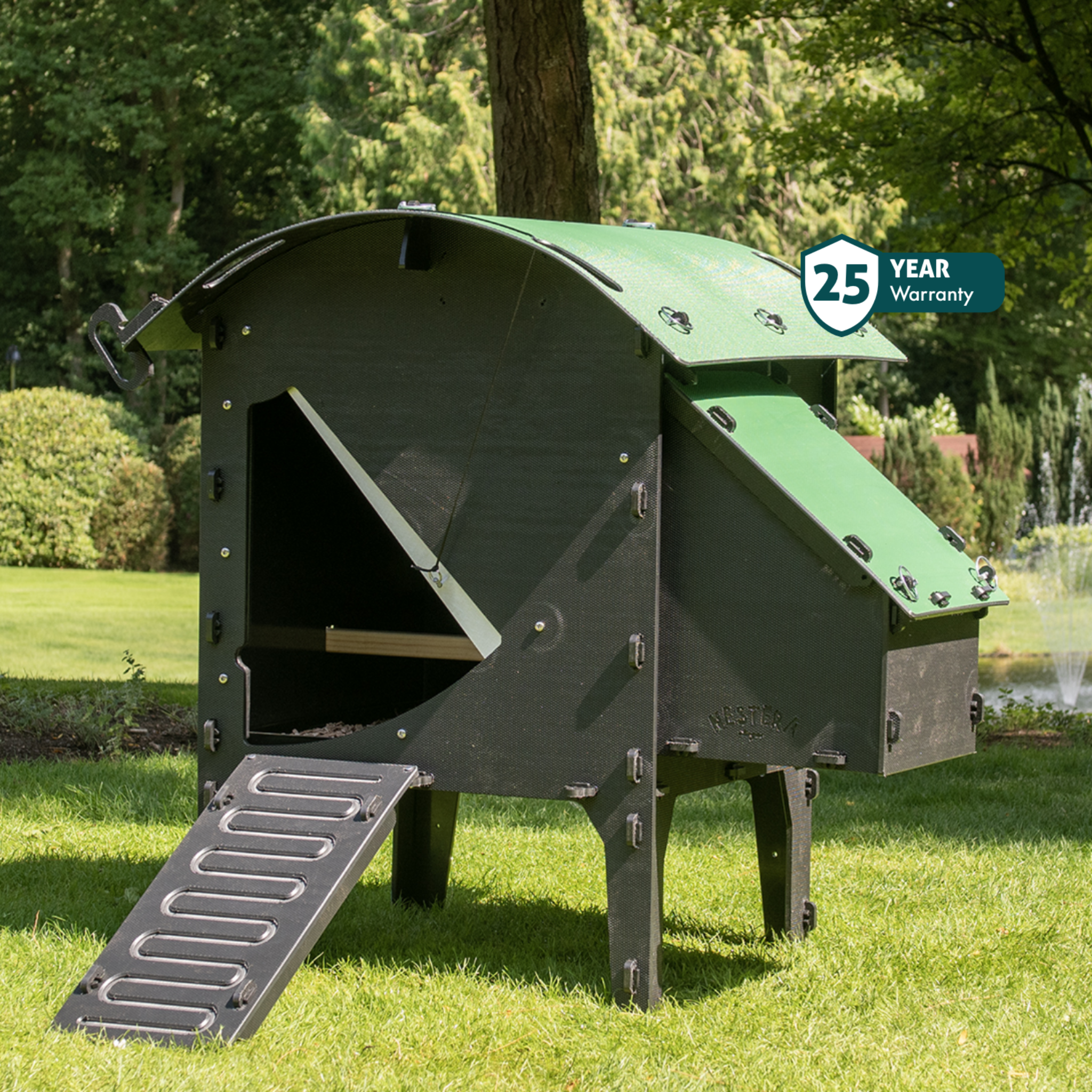 Hatching Time Nestera. Small lodge chicken coop can be seen on grass. Chicken coop has ramp leading up to door. Nesting box can be seen on side of chicken coop.