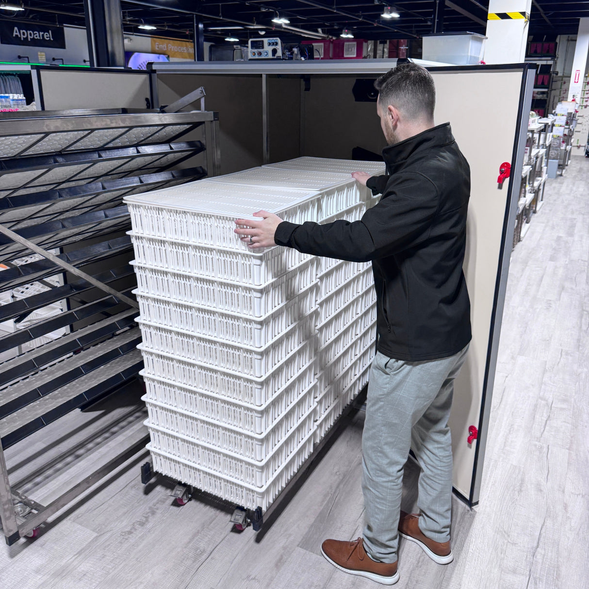 Hatching Time. T series Incubator can be seen with trolley being taken out full of hatching baskets in warehouse.