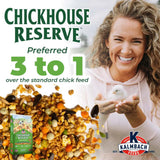 Hatching Time Kalmbach Feeds. Chickhouse reserve 30 lb bag front can be seen in image on top of pile of feed. A woman is holding a chick in her hands. Text reads Preferred 3 to 1 over the standard chick feed.