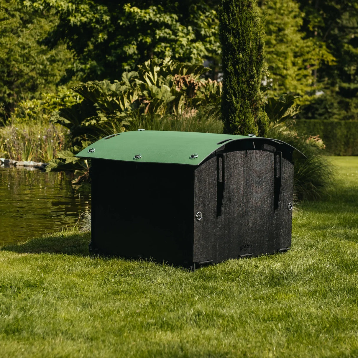 Hatching Time Nestera. Duck house rear can be seen in image. Duck house has green rounded roof, black walls and floor and walk-up ramp. Door is open.