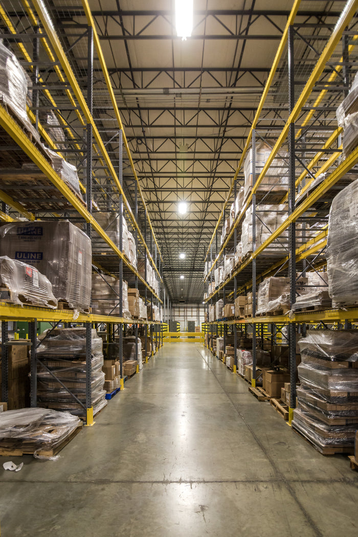 Hatching Time. Warehouse corridor is visible in image. Pallets can be seen stacked on top of shelves along corridor.