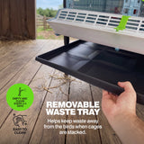 Close-up of removable waste tray being pulled from a Cimuka chick brooder for convenient cleaning and poultry waste collection.