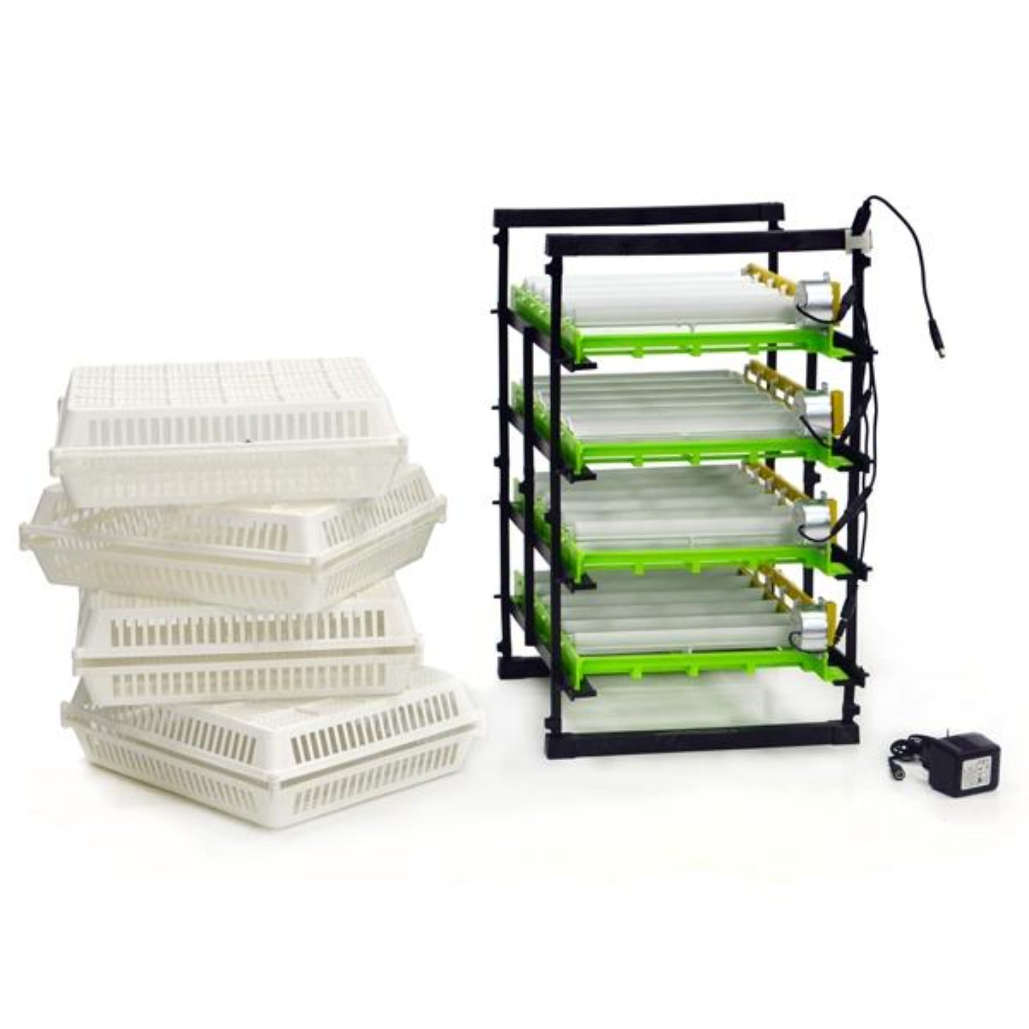 Hatching Time Cimuka. 120 egg turner with setting trays seen on egg rack. Egg turning motors visible. Hatching baskets can be seen next to racks. Power cord visible in front of egg racks.