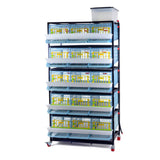 Hatching Time Cimuka 5 Layer Quail Cage front visible. Feeding trough is located on front of brooders.  Plastic doors with locks can be seen. Manure trays and egg collection roll-out trays visible on front. Quail Cages are on Metal frame with rolling casters for mobility.