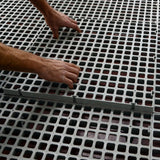 Hatching Time Cimuka. Hands placing Large Hole slat flooring together.