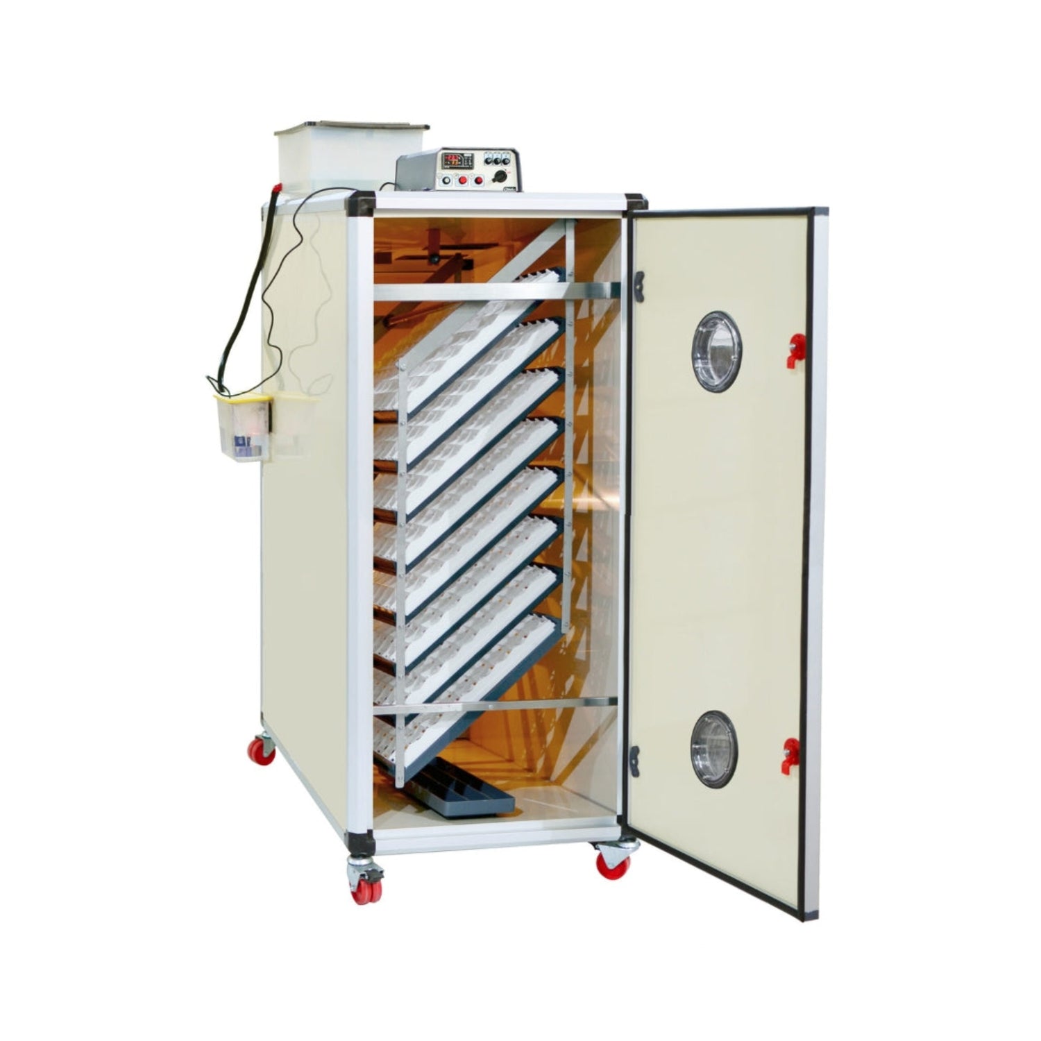 Hatching Time Cimuka. T1280S egg incubator shown with door open. Egg setter trays are inside showing capacity of up to 1280 chicken eggs. Humidity tray can be seen inside of incubator. Digital control can be seen on top of incubator in front o water reservoir that is connected to Humisonic Humidifier.