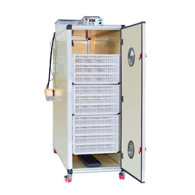 Hatching Time Cimuka. T1600H Incubator shown with doors open to see 10 Hatching baskets. Humidity tray is on floor of incubator. Digital controls on top of incubator can be seen in front of water reservoir that is connected to Humisonic humidifier on side of incubator.